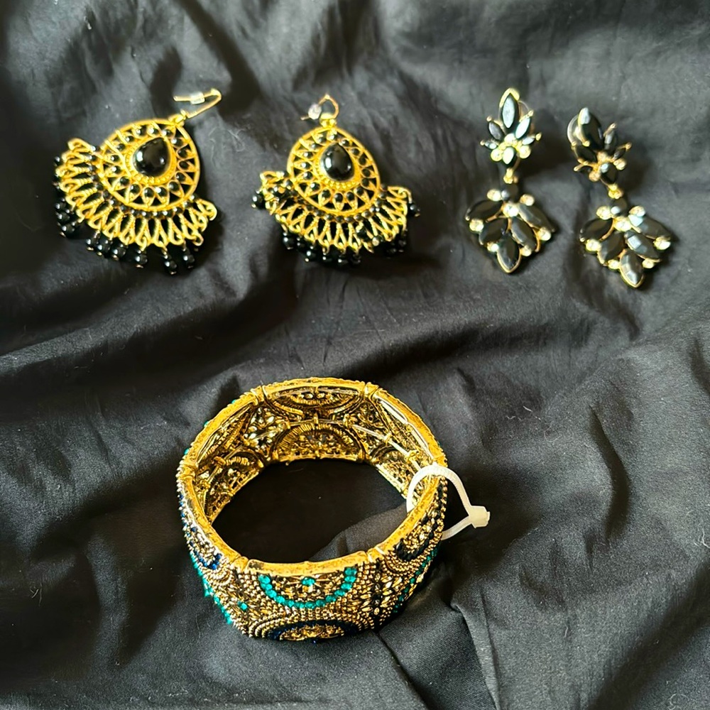 2 gold/black earrings and a bracelet